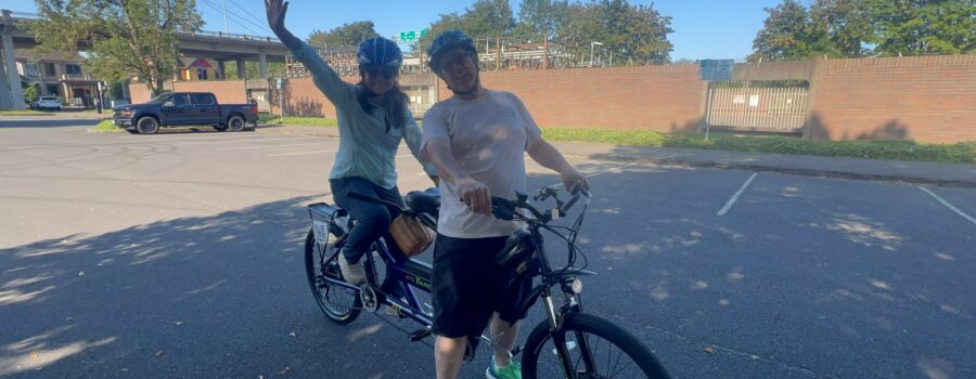 Picture showing the stoker fully seated with feet on pedals while the Captain is straddling the bike with the brakes on. This shows how you should be mounted on a Tandem to start.